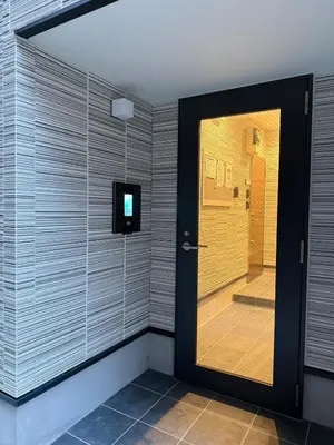 a bathroom with a glass door with a shower at Nexus Villa Morishita in Tokyo