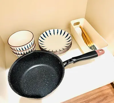 a frying pan and other utensils on a counter at Nexus Villa Morishita in Tokyo
