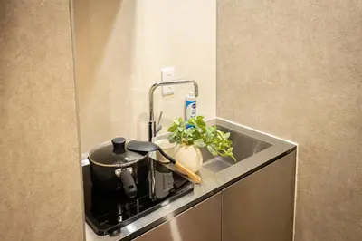 a kitchen counter with a pot on a stove at New mansion 5 mins from Yoyogi stations in Tokyo