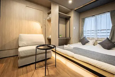 a small room with two beds and a table at New mansion 5 mins from Yoyogi stations in Tokyo