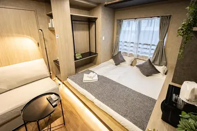 a small room with a bed and a mirror at New mansion 5 mins from Yoyogi stations in Tokyo