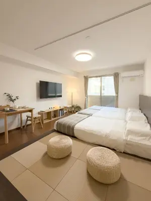 a large bedroom with a large bed and a tv at ISSHUKU NOMA\u6c60\u888bII 102 - Quad Room in Tokyo