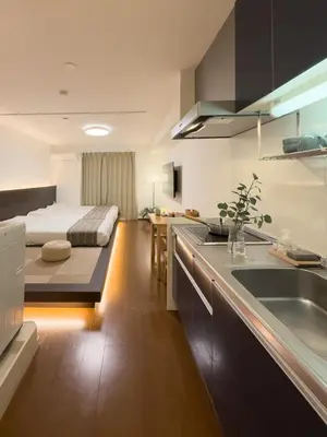 a kitchen with a sink and a bed in a room at ISSHUKU NOMA\u6c60\u888bII 103 - Quad Room in Tokyo
