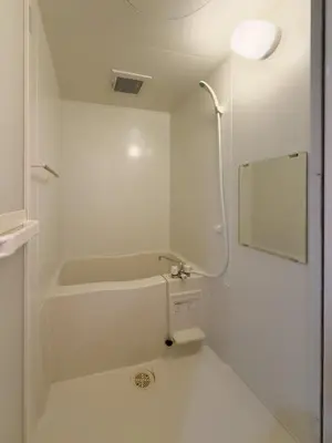 a bathroom with a tub and a toilet and a mirror at ISSHUKU NOMA\u6c60\u888bII 105 - Quad Room in Tokyo