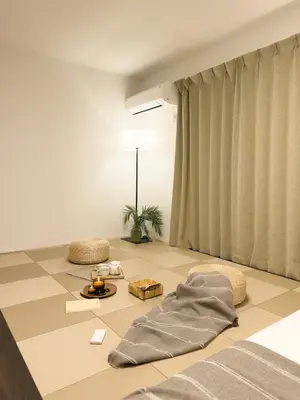 a living room with a bed and a table with a lamp at ISSHUKU NOMA\u6c60\u888bII 301 - Spacious Room for 5 Guests in Tokyo