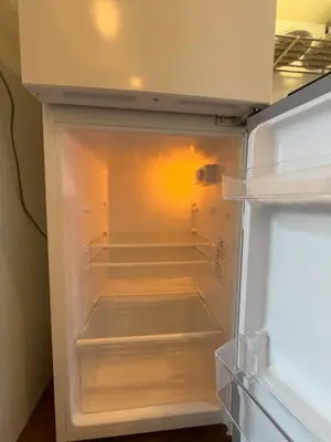 an empty refrigerator with its door open in a kitchen at ISSHUKU NOMA\u6c60\u888bII 301 - Spacious Room for 5 Guests in Tokyo