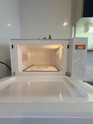 an open microwave oven with its door open at ISSHUKU NOMA\u6c60\u888bII 302 - Quad Room in Tokyo