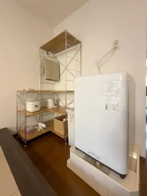 a room with a white refrigerator and a tv at ISSHUKU NOMA\u6c60\u888bII 302 - Quad Room in Tokyo