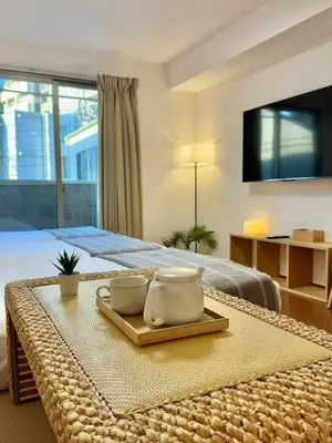 a bedroom with a bed with a tray with two dishes at ISSHUKU NOMA\u6c60\u888bII 303 - Quad Room in Tokyo