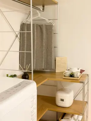 a room with a bed and a shelf with towels at ISSHUKU NOMA\u6c60\u888bII 303 - Quad Room in Tokyo