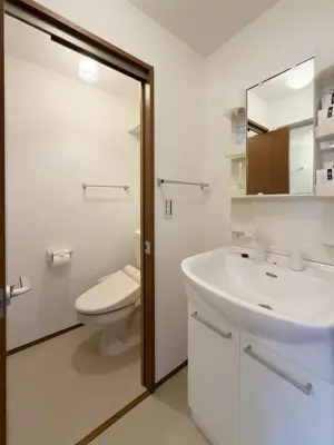 a bathroom with a toilet and a sink and a mirror at ISSHUKU NOMA\u6c60\u888bII 303 - Quad Room in Tokyo