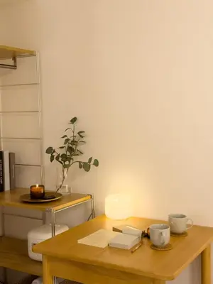 a wooden table with two cups and a candle on it at ISSHUKU NOMA\u6c60\u888bII 305 - Quad Room in Tokyo