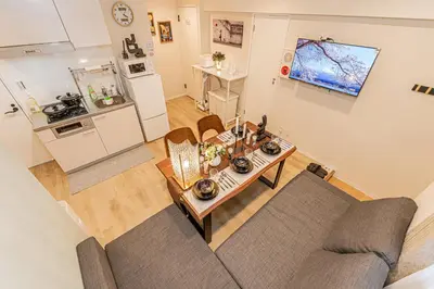 an overhead view of a living room with a couch and a table at 80m to Aoto Station Elevator Access 35 Min Direct to Haneda Airport Direct Train to Narita Airport Easy Access to Ginza Asakusa Disney Skytree Convenience Store and Pharmacy Downstairs in Tokyo