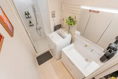 a bathroom with a sink and a toilet and a mirror at 80m to Aoto Station Elevator Access 35 Min Direct to Haneda Airport Direct Train to Narita Airport Easy Access to Ginza Asakusa Disney Skytree Convenience Store and Pharmacy Downstairs in Tokyo