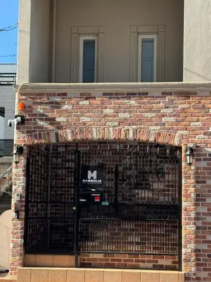 a brick building with a gate in front of it at New Open! Shinjuku 5 bedrooms 3 bathrooms Large Villa 2000 sq ft, kids play room, max 16ppl, 4min train to Shinjuku - Magnolia Hotel Shinjuku in Tokyo