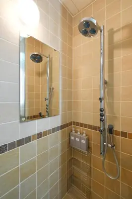 a bathroom with a shower with a mirror at New Open! Shinjuku 5 bedrooms 3 bathrooms Large Villa 2000 sq ft, kids play room, max 16ppl, 4min train to Shinjuku - Magnolia Hotel Shinjuku in Tokyo