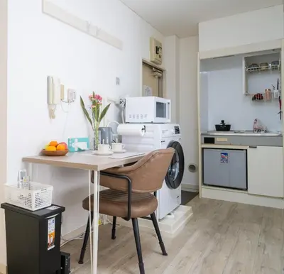 a small kitchen with a table and a microwave at \u5466\u5466\u9e7f\u9e23\u6c11\u5bbf301\u4e0a\u91ce\u9644\u8fd1\u5165\u8c37\u4e0a\u91ce\u516c\u56ed\u6b65\u884c\u5708 \u65e5\u6bd4\u8c37\u7ebf jr\u7ebf \u53cc\u7ebf\u53ef\u5229\u7528 in Tokyo
