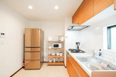 a kitchen with a refrigerator and a sink at \u8fd1skytree 3\u5c42\u522b\u5885 \u5168\u65b0\u88c5\u4fee \u8f66\u7ad98\u5206\u949f 3\u5ba41\u53851\u6d74\u5ba42\u536b\u751f\u95f4 \u8bbe\u65bd\u9f50\u5168 \u6700\u59278\u4ebaEasy Access to Skystree 3 rooms 1dining room 1 bathrooms 2toilets Max 8P 8mins to St a in Tokyo