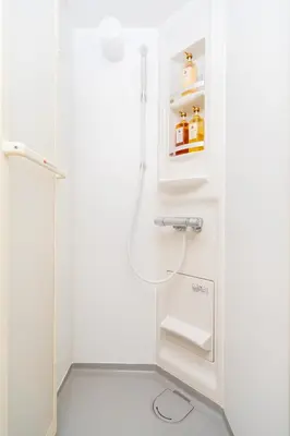 a white bathroom with a shower and a sink at Sky land House Asakusa in Tokyo