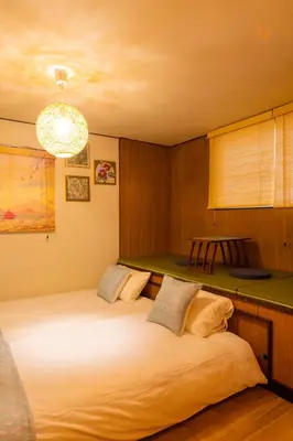 a bedroom with two beds with a green counter at Sky land House Asakusa in Tokyo