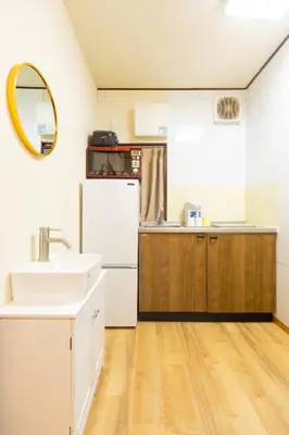 a kitchen with a sink and a white refrigerator at Sky land House Asakusa in Tokyo