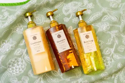 three bottles of soap sitting on a table at Sky land House Asakusa in Tokyo