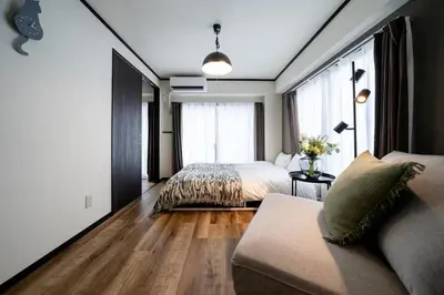 a bedroom with a bed and a couch at \u6cca\u5bb6\u6771\u795eHakuya toshin in Wada