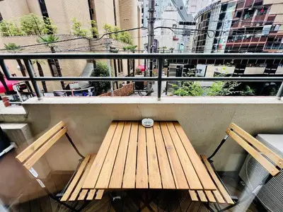 a bench on a balcony with a view of a city at TokyoShinjuk Station800meterskabukicho2minutes224 in Tokyo