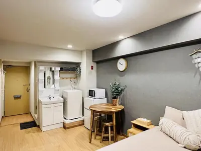 a small kitchen with a table and a refrigerator at TokyoShinjuk Station800meterskabukicho2minutes224 in Tokyo