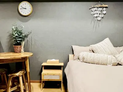 a bedroom with a bed and a clock on the wall at TokyoShinjuk Station800meterskabukicho2minutes224 in Tokyo