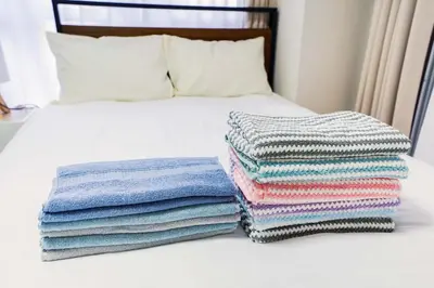 two stacks of towels sitting on a bed at 102Room,Free Parking Only 1 Stop from Ikebukuro Entire 33m on 1st Floor 2 Bedrooms for up to 6 Guests 3Minute Walk to Don Quijote in Tokyo