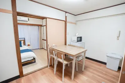 a small room with a table and a bed at 102Room,Free Parking Only 1 Stop from Ikebukuro Entire 33m on 1st Floor 2 Bedrooms for up to 6 Guests 3Minute Walk to Don Quijote in Tokyo