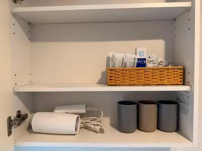 a closet with a shelf with a basket and trash at 102Room,7-minute walk from Uguisudani Station located on the 1nd floor of an apartment-style building Twin room No elevator in Tokyo