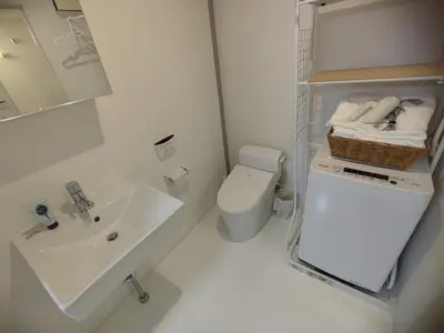 a white bathroom with a sink and a toilet at 401Room,7-minute walk from Uguisudani Station located on the 4nd floor of an apartment-style building Twin room No elevator in Tokyo