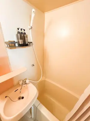 a bathroom with a sink and a bath tub at 203 Quiet area walking distance of Shinjuku Shin-Okubo district in Tokyo