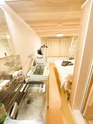 a kitchen with a sink in a room with a bed at 203 Quiet area walking distance of Shinjuku Shin-Okubo district in Tokyo