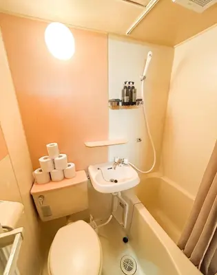 a small bathroom with a toilet and a sink at 203 Quiet area walking distance of Shinjuku Shin-Okubo district in Tokyo