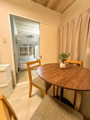 a dining room with a wooden table and chairs at Shinjyuku area walk to Kabuki cho 15 min in Tokyo