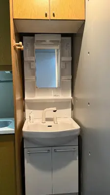 a bathroom with a sink and a mirror at Moon Base Tokyo Inn in Tokyo