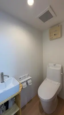 a bathroom with a white toilet and a sink at Moon Base Tokyo Inn in Tokyo