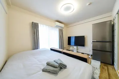 a bedroom with a bed with towels on it at 22\u30e1\u30be\u30f3\u30b8\u30e5\u30cd\u30b9 in Tokyo