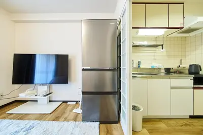 a kitchen with a refrigerator and a tv in it at 22\u30e1\u30be\u30f3\u30b8\u30e5\u30cd\u30b9 in Tokyo