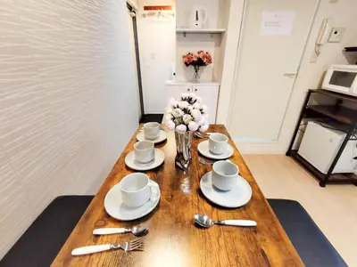 a wooden table with cups and saucers on it at Shinjuku center area-\u65b0\u5927\u4e45\u4fdd\u7ad94\u5206-\u65b0\u5bbf10\u5206-2room-Loft-Max5p-\u76f4\u8fbe\u6d89\u8c37\u4e0a\u91ce\u539f\u5bbf\u94f6\u5ea7 in Tokyo