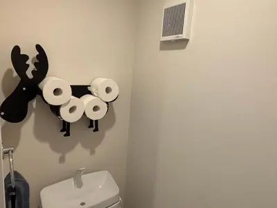 a bathroom with a toilet with a reindeer on the wall at \u3055\u304f\u3089\u65c5\u9928 \u9ad8\u5186\u5bfa\u5317\u5343\u5229\u4f11 301\u53f7\u5ba4 in Tokyo