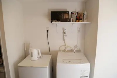 a laundry room with a washer and a washer and dryer at PR204 Shinjuku Perfect location for Kabukichō in Tokyo