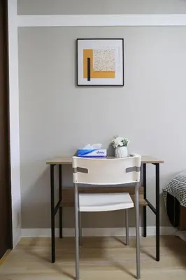 a dining room table with a chair and a picture at PR204 Shinjuku Perfect location for Kabukichō in Tokyo