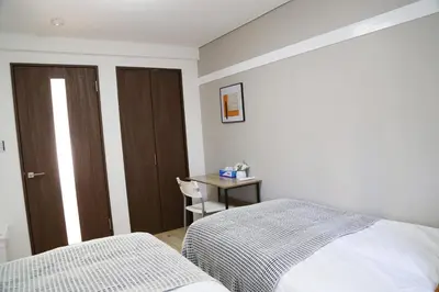 a bedroom with a bed and a desk with a table at PR204 Shinjuku Perfect location for Kabukichō in Tokyo