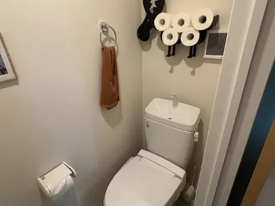 a small bathroom with a toilet and rolls of toilet paper at \u3055\u304f\u3089\u65c5\u9928 \u9ad8\u5186\u5bfa\u5317 \u5343\u5229\u4f11401\u53f7\u5ba4 in Tokyo