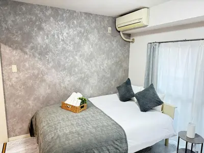 a bedroom with two beds and a wall at Waseda University area 3F6 with elevator in Tokyo