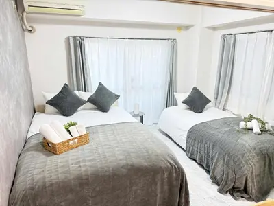a bedroom with two beds and two windows at Waseda University area 3F6 with elevator in Tokyo